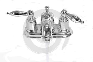 Chromium water tap with flowing water