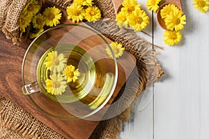 Chrysanthemum tea and Chrysanthemum flower on white wood background. Healthy beverrage for drink. Herbs and medical concept