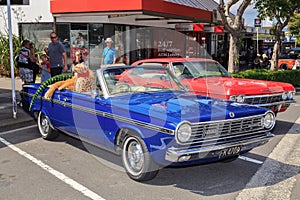 A blue 1965 Chrysler Valiant at an outdoor classic car show