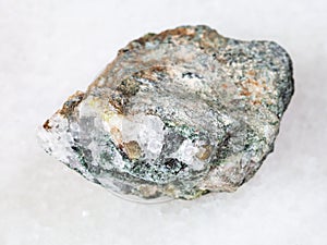 Chrysoberyl crystals in rough beryl rock on white
