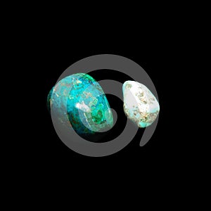 Two tumbling chrysocolla stones on black background