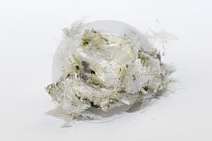 Chrysotile asbestos fibers lie in a heap on white background