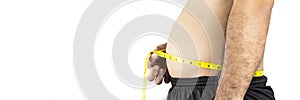 A chubby Asian man measures his waist with a yellow tape measure,panoramic horizontal copy space on white background