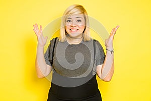 Chubby Caucasian woman looking super excited about something in a studio