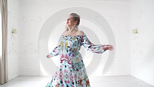 Chubby girl in beautiful dresse posing in bright studio. Plump woman posing in beautiful outfit.