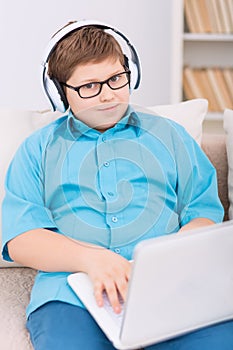 Chubby kid playing games on the laptop