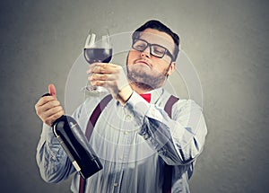 Snobby wine expert exploring drink photo