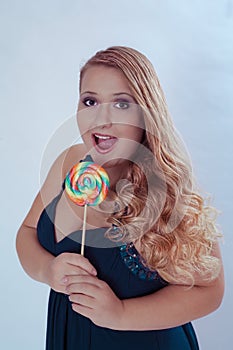 Chubby Woman Holding Lollipop with Mouth Open