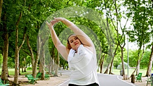 Chubby woman streching in the park