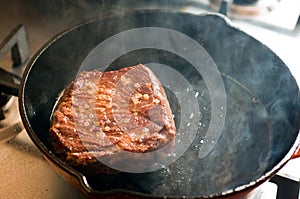 Chuck steak on skillet