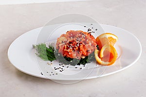 Chuka salad, salmon, orange, black sesame, isolated on a plate