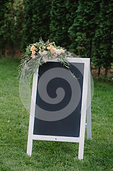 Chulk board, which stands on the grass with wedding inscription
