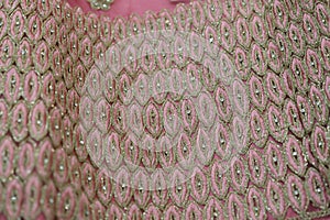 Chumki work on a pink lehenga border