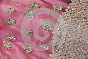 Chumki work on a pink lehenga border