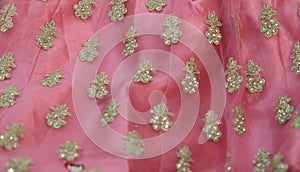 Chumki work on a pink lehenga border