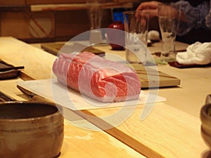 A chunk of fatty tuna on a cutting board