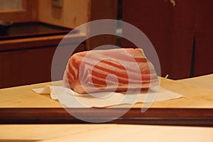 A chunk of fatty tuna on a cutting board