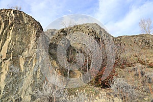 A chunk of mountain, with blue sky, at Knox mountain park in Canada