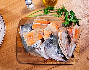 Chunks of raw salmon and fresh vegetables - ingredients for preparing delicious lunch