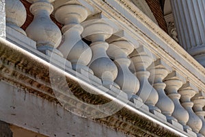 Chunky balusters on an exterior porch with stains and mold underneath, architectural detail