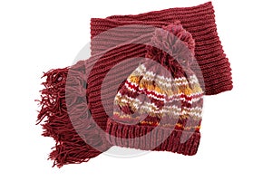 Chunky red knitted winter clothes bobble hat scarf isolated white background