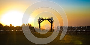 Chuppah silhouetted by the golden setting sun