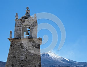 Church with active Guallatiri Volcano in the background photo