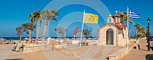 Church of Agios Dimitrios, Analipsi, Crete, Greece.  Analipsi beach with palms and Church