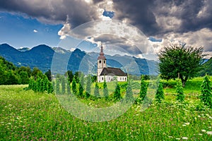 Church with agricultural sourrounding in the slovenian alpine area photo