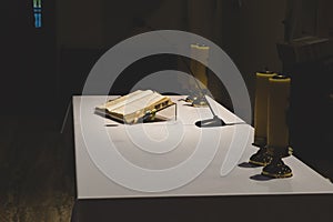 Church altar with open bible book and candles