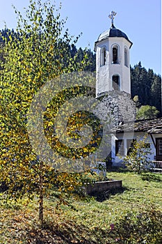 Church of the Assumption, river and Autumn tree in town of Shiroka Laka, Bulgaria photo