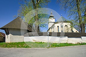 The Church of the Assumption of the Virgin Mary in Lubica with fortication wall