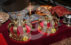 Church attributes for wedding ceremony. Gold crowns are on the altar. Church book Gospel