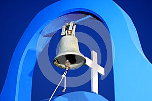 Church bell and cross of a greek orthodox church