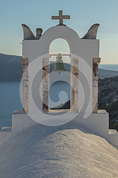 Church bell in oia, Santorini. Sunset. Greece.