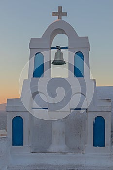 Church bell in oia, Santorini. Sunset. Greece.