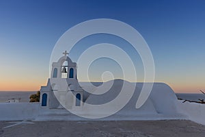 Church bell in oia, Santorini. Sunset. Greece.