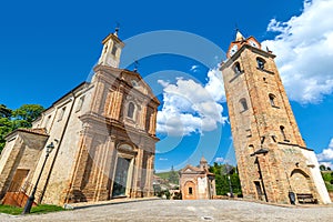 Church and bell tower under blue sky in Monforte d`Alba, Italy.
