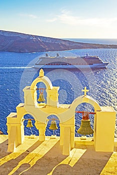 Church bells and cruise ship passing Oia town Santorini Greece