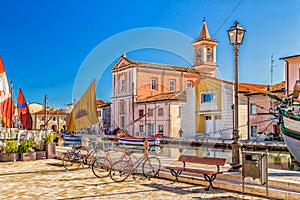 Church, boats and bycicles on Canal Port