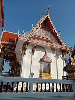 Church of Buddhist temple isolated on blue sky background closeup.