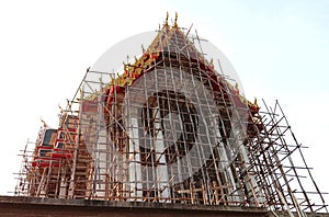 Church of Buddhist temple not finished under construction isolated on blue sky background closeup.