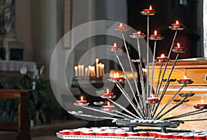 Church with candelabra and lit candles during the prayers of the