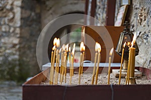 Church candles burning at an orthodox monastery in Greece.