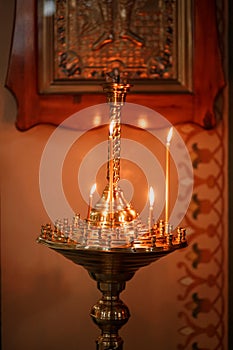 Church candlestick with many burning candles