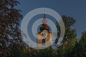 Church and castle in Petrovice village in central Bohemia in summer evening
