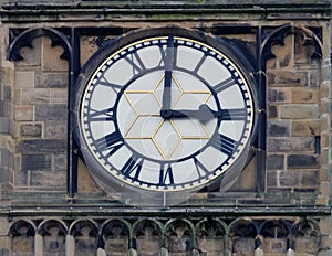 Church clock white face with roman numerals at three o clock