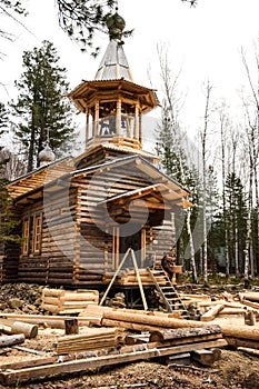 Church construction process. construction of a wooden chapel in a pine forest.