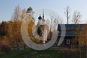 Church, country house and spring birch trees