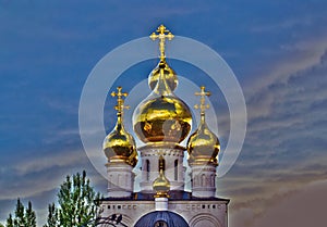 Church crosses and golden domes against a disturbing dark sky